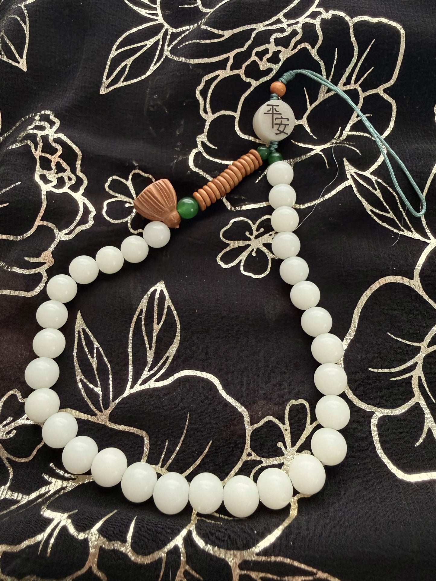 Handheld Lotus Pod & 'Ping An' Peace Worry Beads – Serene White & Jade Green Holding Bracelet