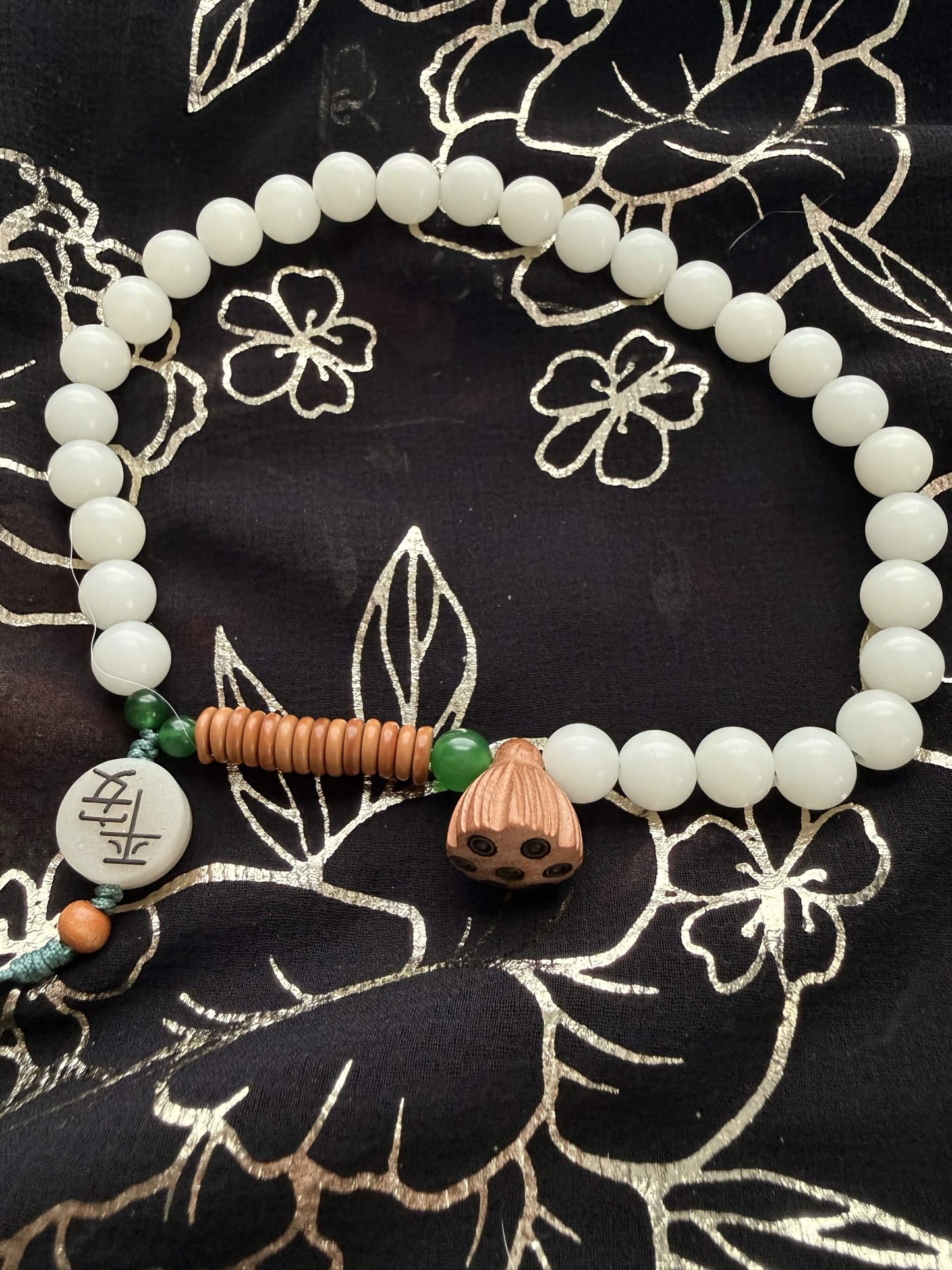 Handheld Lotus Pod & 'Ping An' Peace Worry Beads – Serene White & Jade Green Holding Bracelet